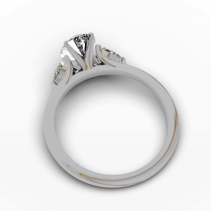 Oval diamond engagement ring with pear-shaped side stones front view.