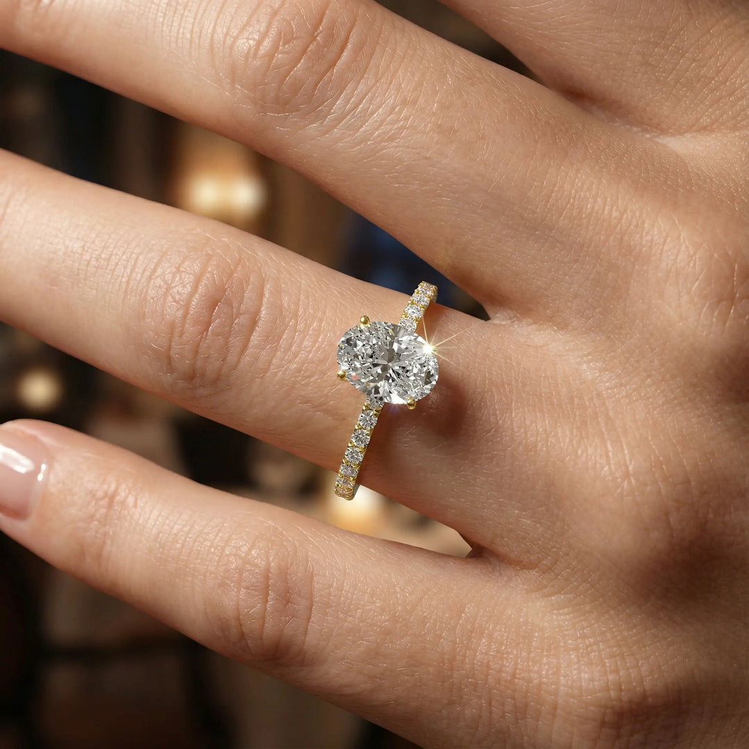 Oval diamond engagement ring with scintillating single row diamond band.