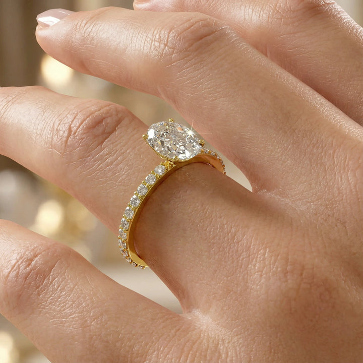 Oval diamond engagement ring with scintillating single row diamond band.