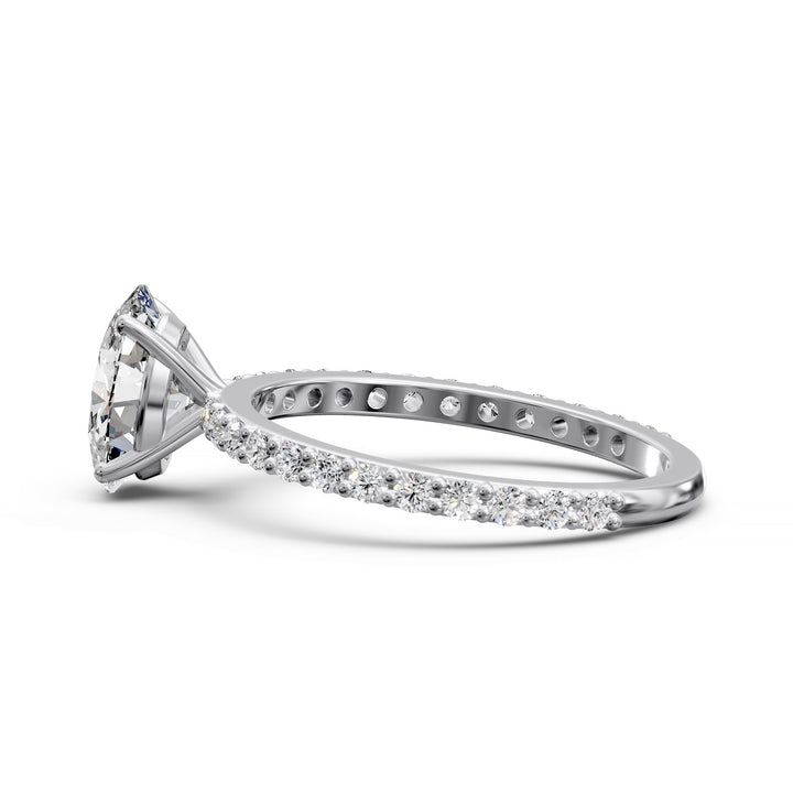 Oval diamond engagement ring with scintillating single row diamond band.
