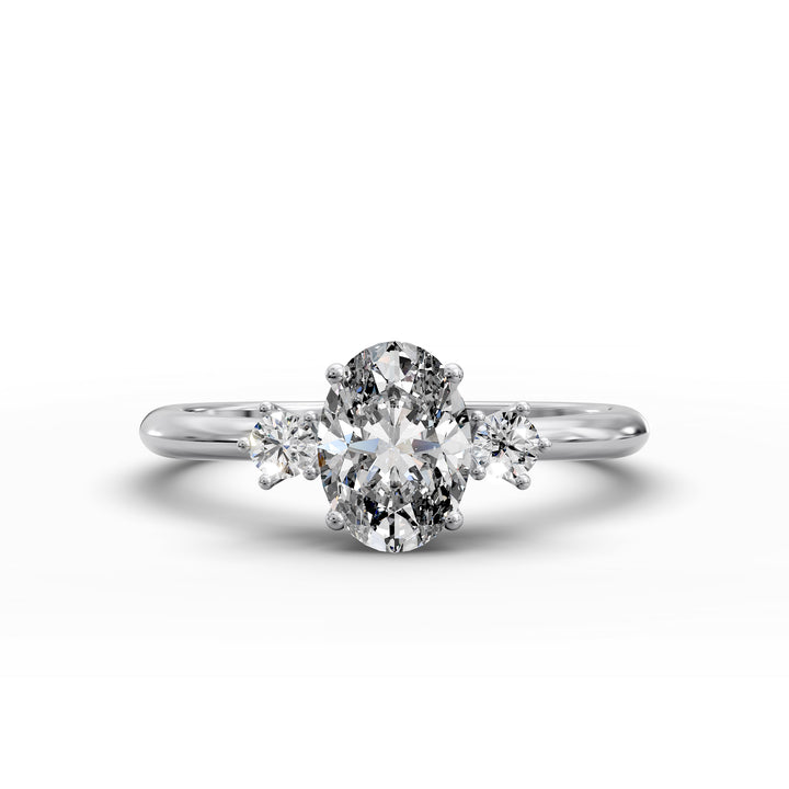 Oval diamond three-stone engagement ring with round side stones shown in display view.