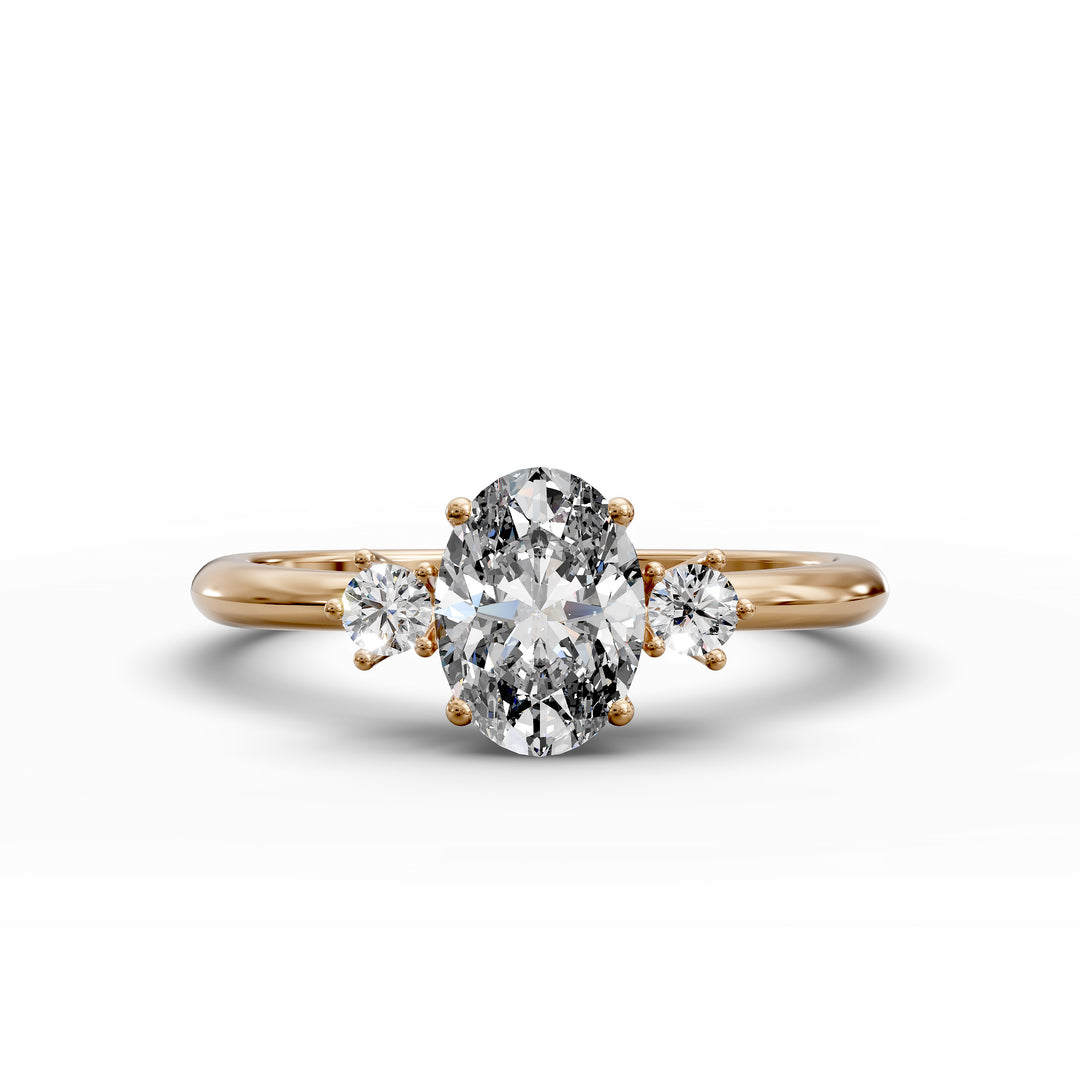 Oval diamond three-stone engagement ring with round side stones shown in display view.