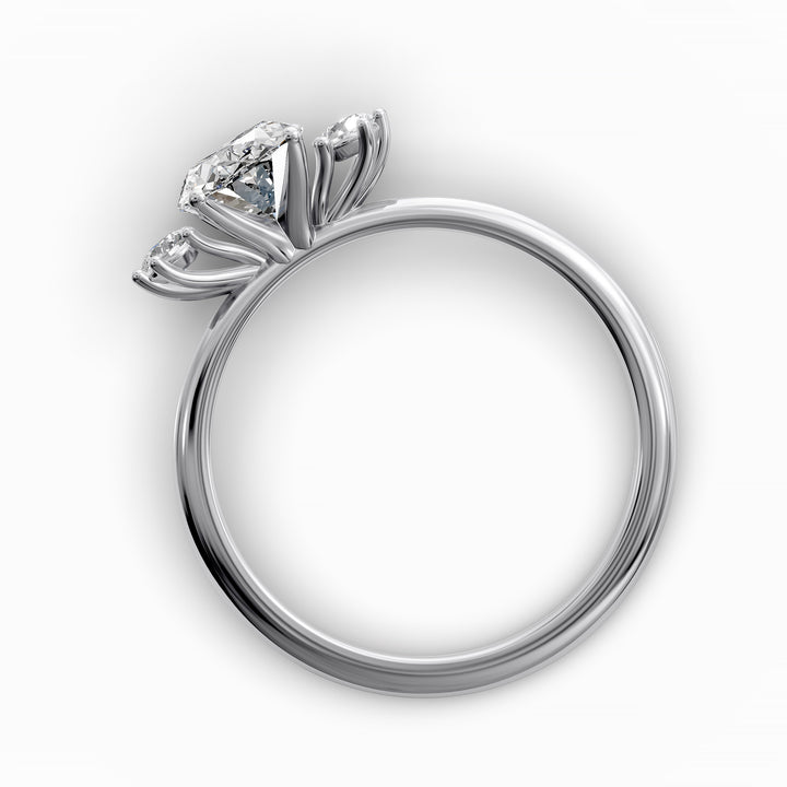 Oval diamond three-stone engagement ring with round side stones shown in display view.