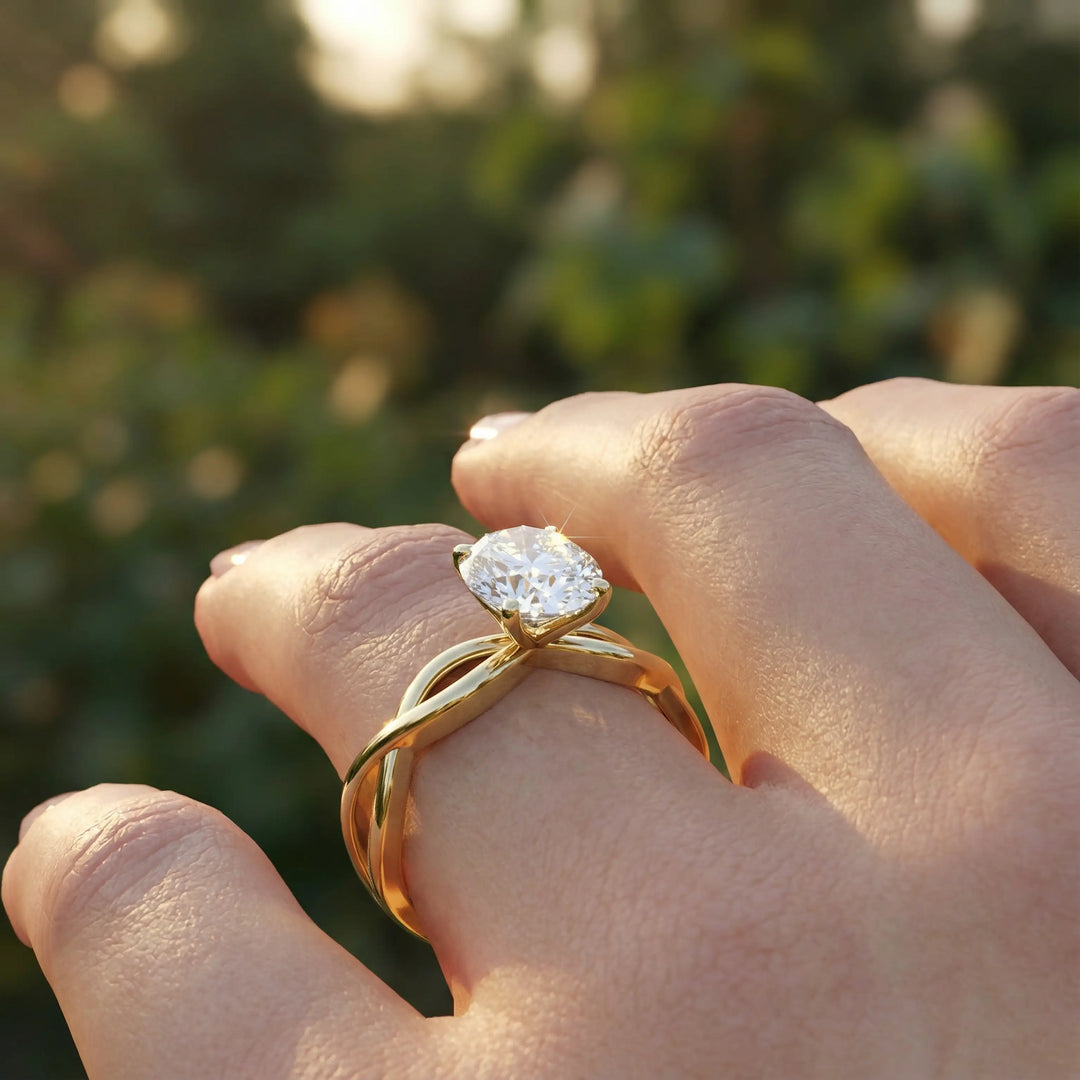 Oval diamond engagement ring with sculpted twisted band design.