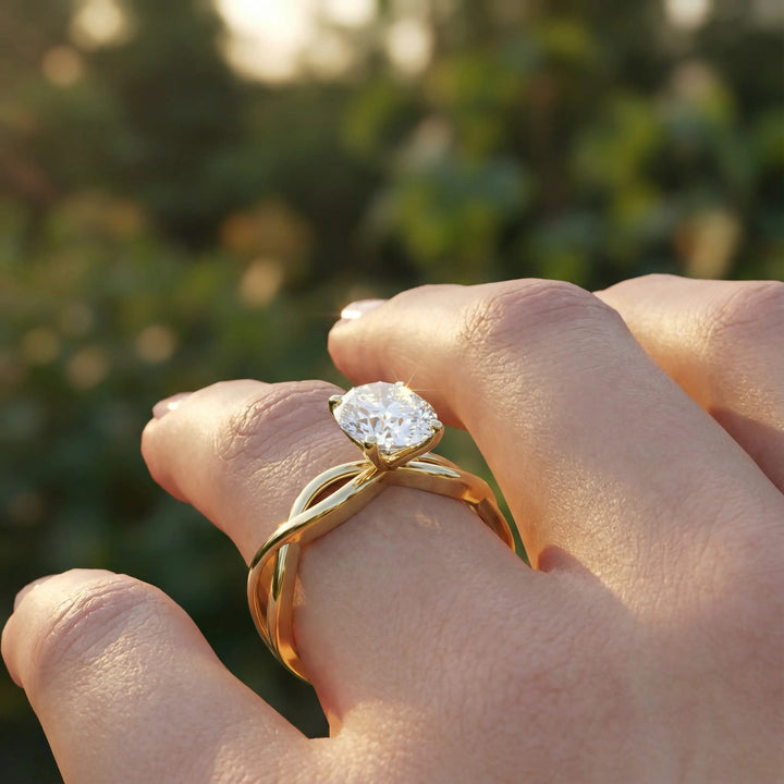 Oval diamond engagement ring with sculpted twisted band design.