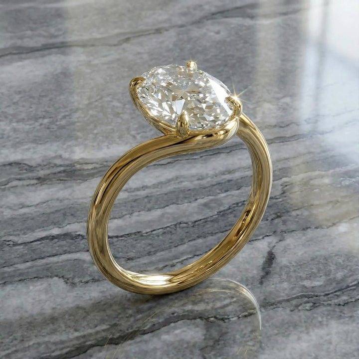Oval lab-grown diamond solitaire engagement ring shown in cathedral setting on reflective surface.
