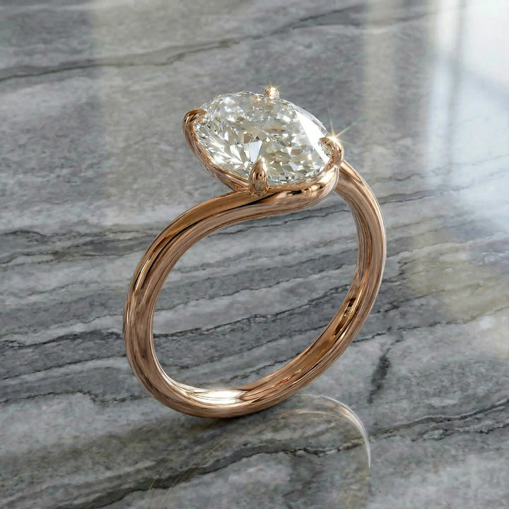 Oval lab-grown diamond solitaire engagement ring shown in cathedral setting on reflective surface.
