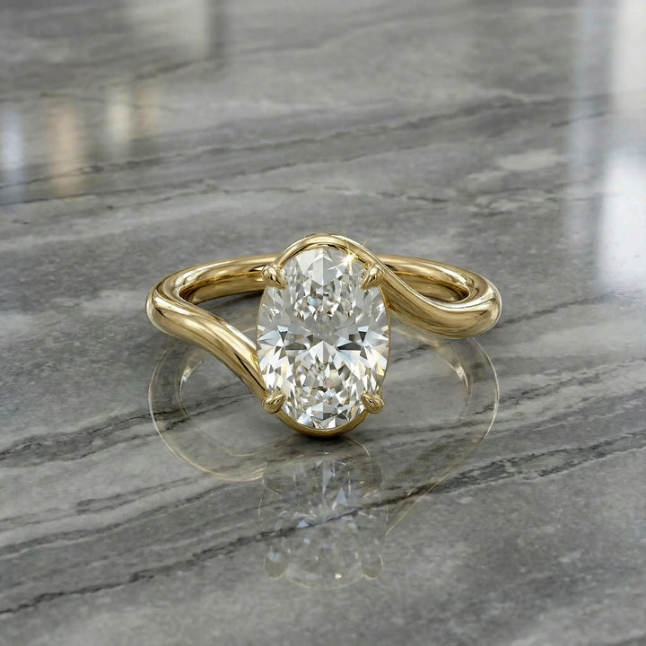 Oval lab-grown diamond solitaire engagement ring shown in cathedral setting on reflective surface.
