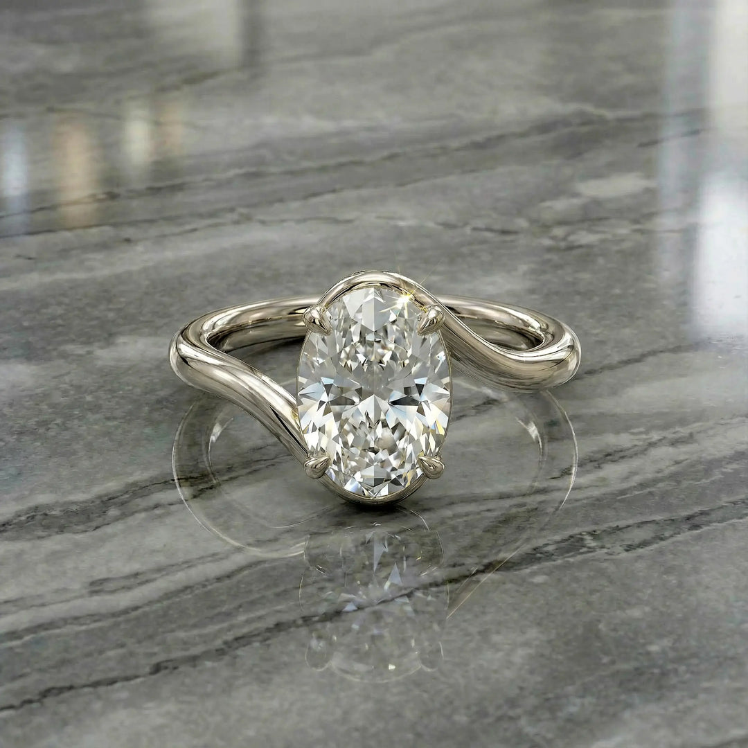 Oval lab-grown diamond solitaire engagement ring shown in cathedral setting on reflective surface.
