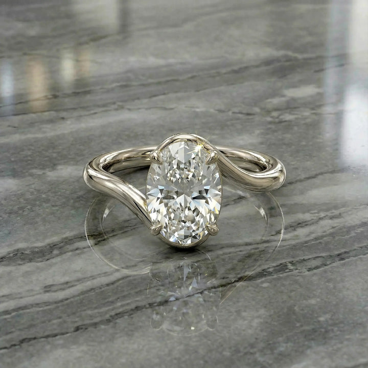 Oval lab-grown diamond solitaire engagement ring shown in cathedral setting on reflective surface.
