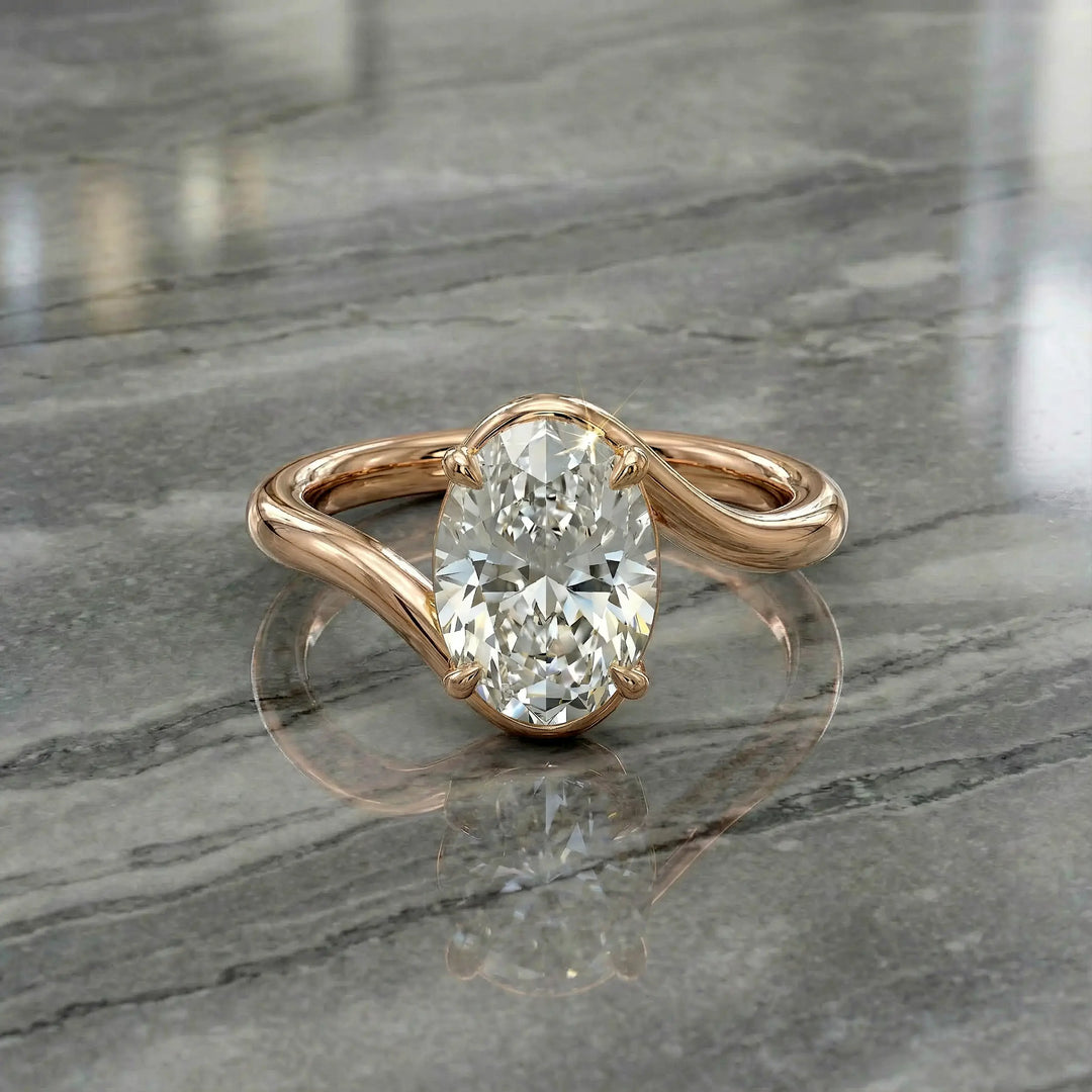 Oval lab-grown diamond solitaire engagement ring shown in cathedral setting on reflective surface.
