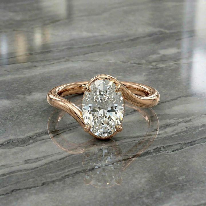 Oval lab-grown diamond solitaire engagement ring shown in cathedral setting on reflective surface.
