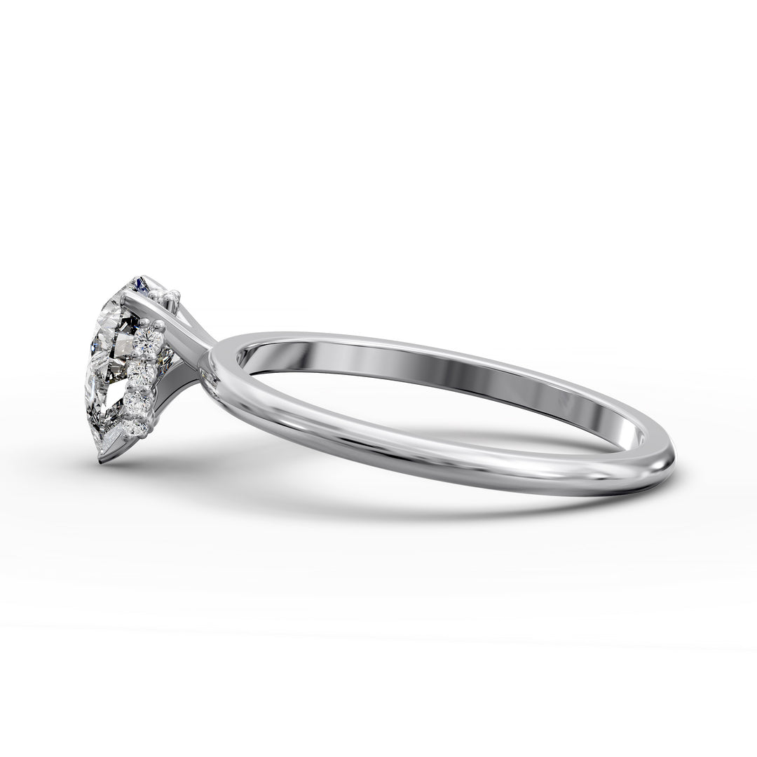 Pear-shaped diamond hidden halo engagement ring with slender band shown in display view.