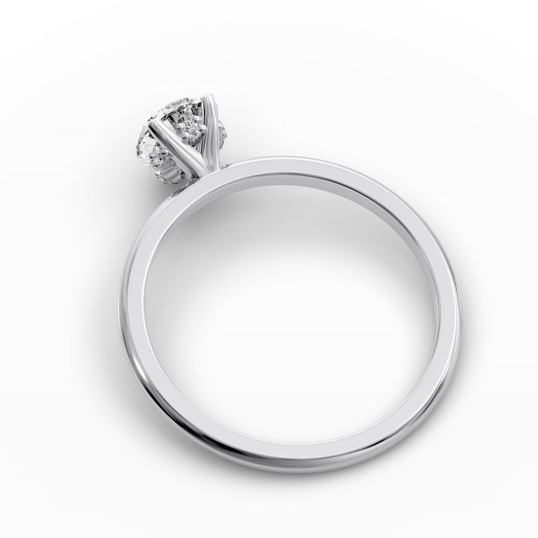 Pear-shaped diamond hidden halo engagement ring with slender band shown in display view.
