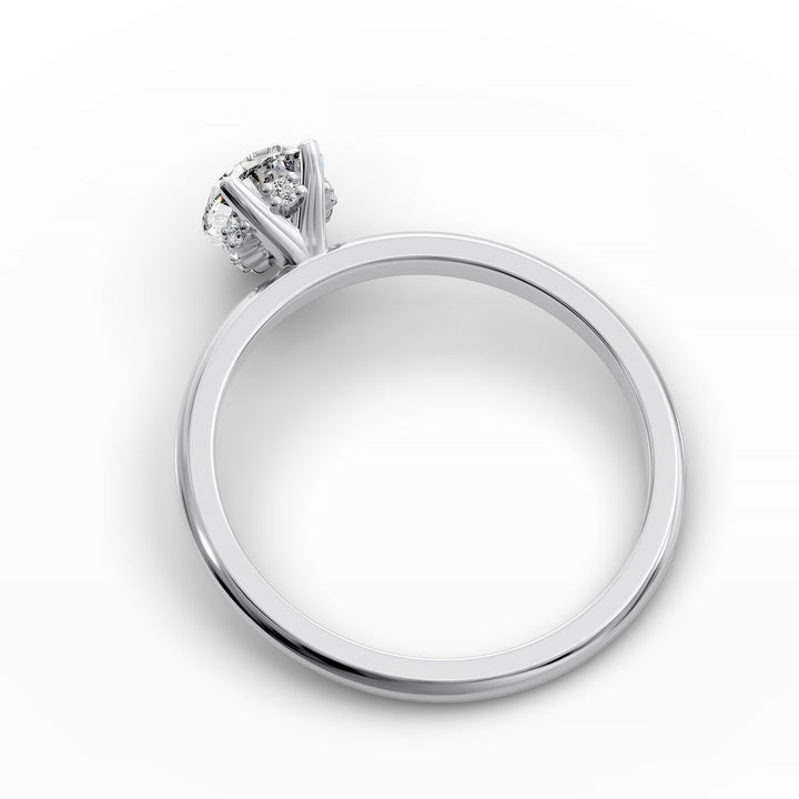 Pear-shaped diamond hidden halo engagement ring with slender band shown in display view.