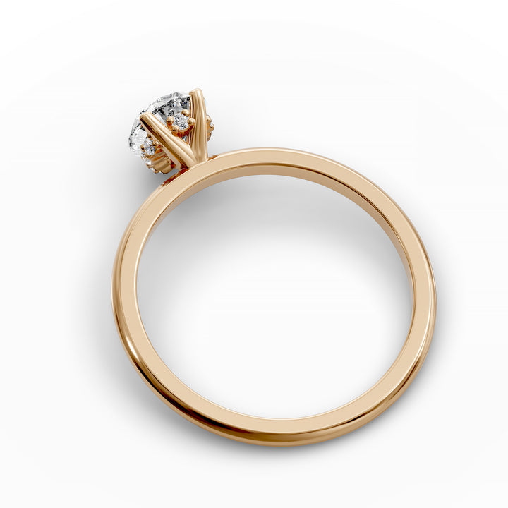 Pear-shaped diamond hidden halo engagement ring with slender band shown in display view.