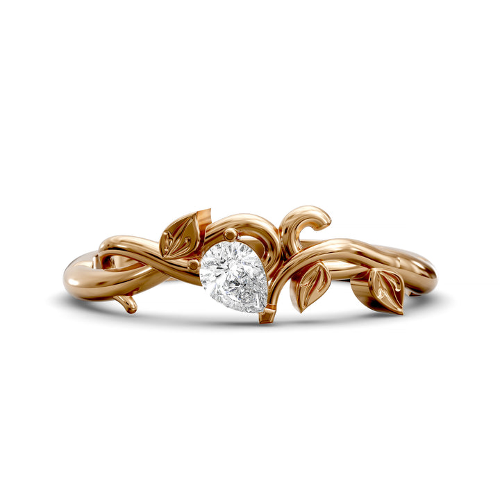 Nature-inspired wedding band with pear-shaped center stone and leaf vine detailing