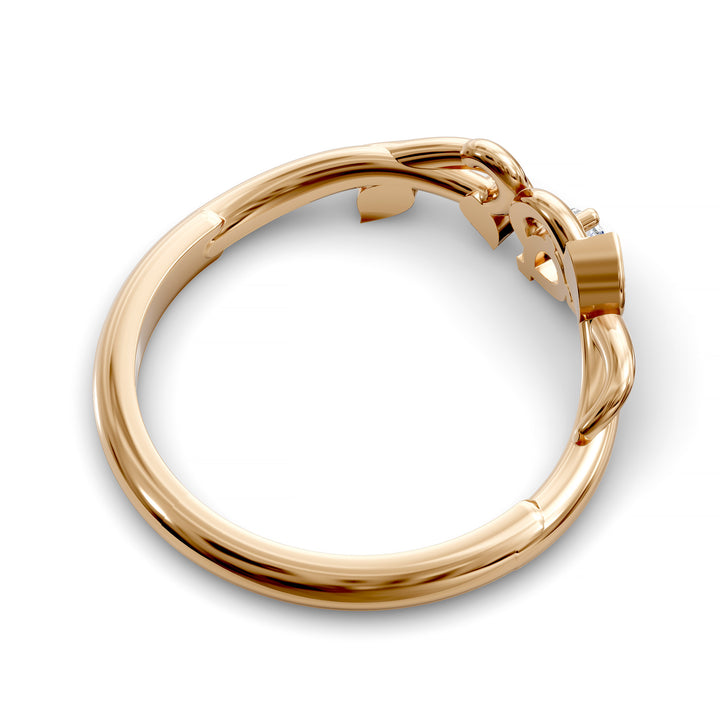 Nature-inspired wedding band with pear-shaped center stone and leaf vine detailing