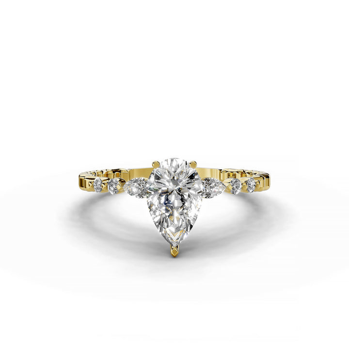 Pear-shaped diamond three-stone engagement ring with geometric segment band shown in display view.