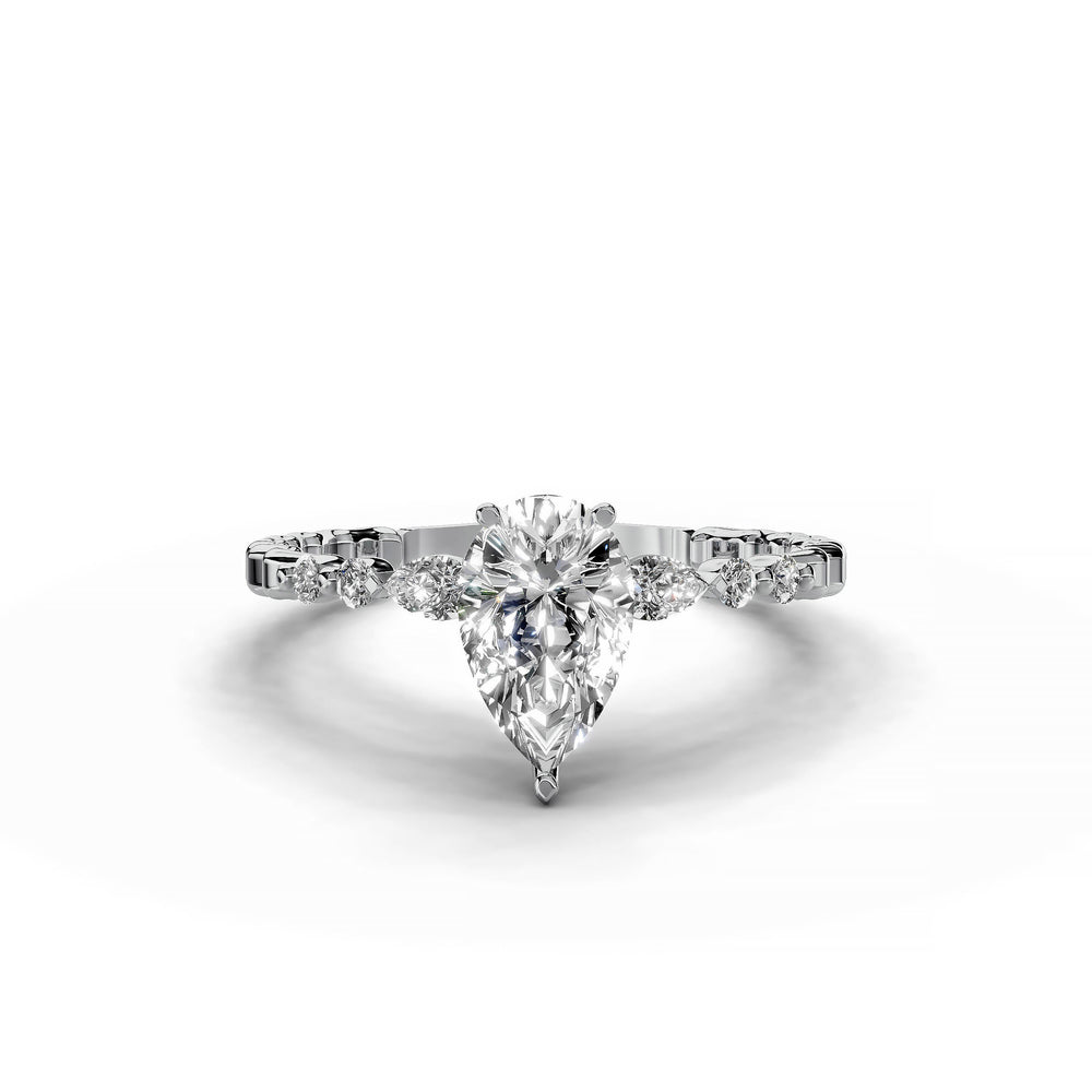 Pear-shaped diamond three-stone engagement ring with geometric segment band shown in display view.