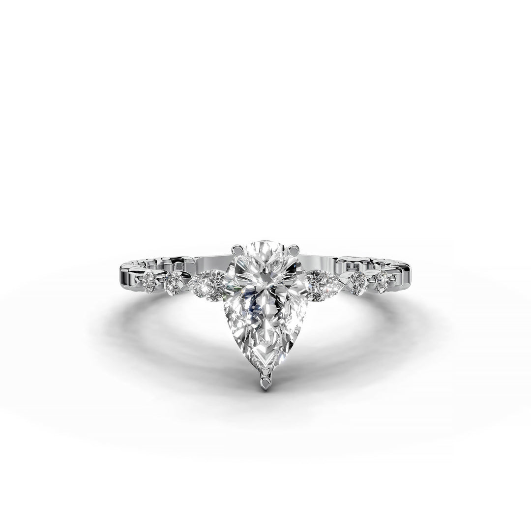 Pear-shaped diamond three-stone engagement ring with geometric segment band shown in display view.