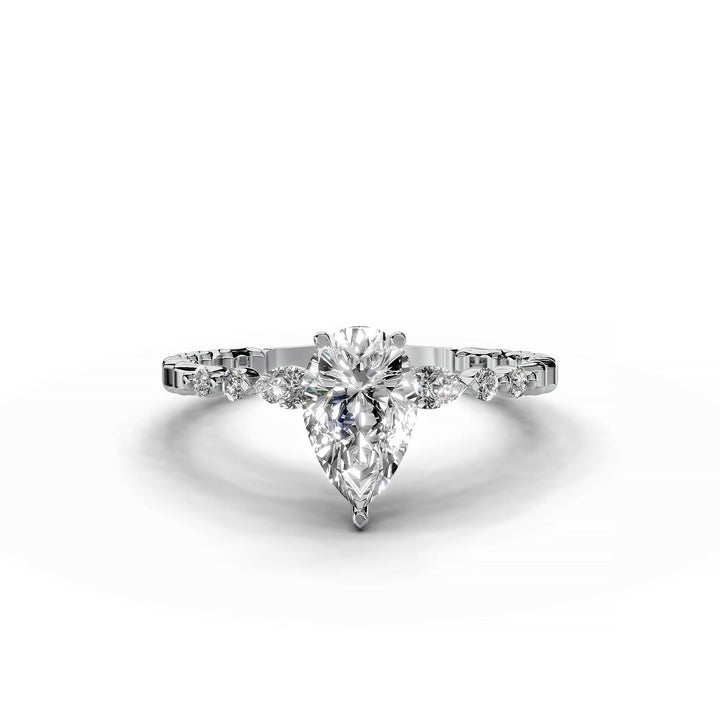 Pear-shaped diamond three-stone engagement ring with geometric segment band shown in display view.