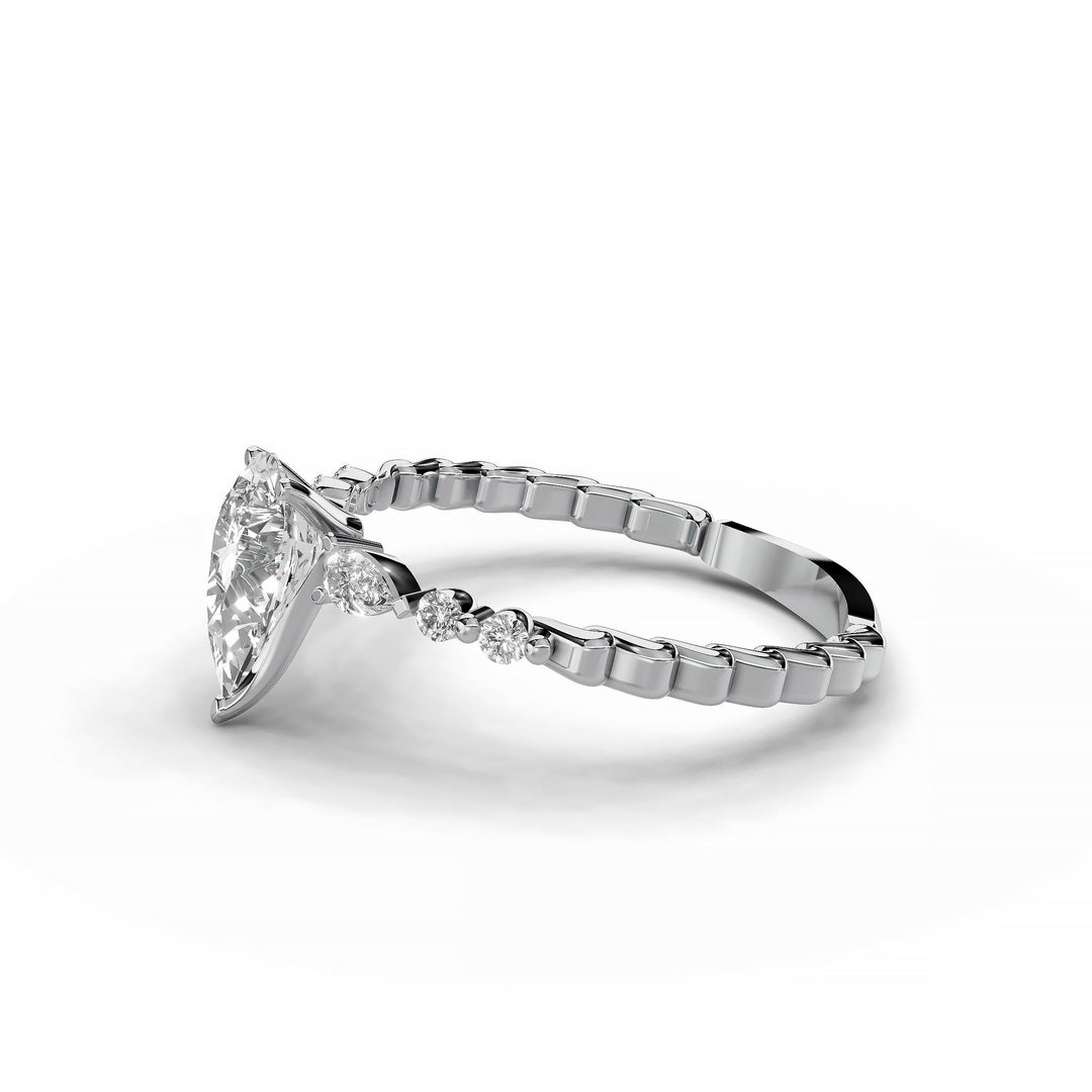 Pear-shaped diamond three-stone engagement ring with geometric segment band shown in display view.
