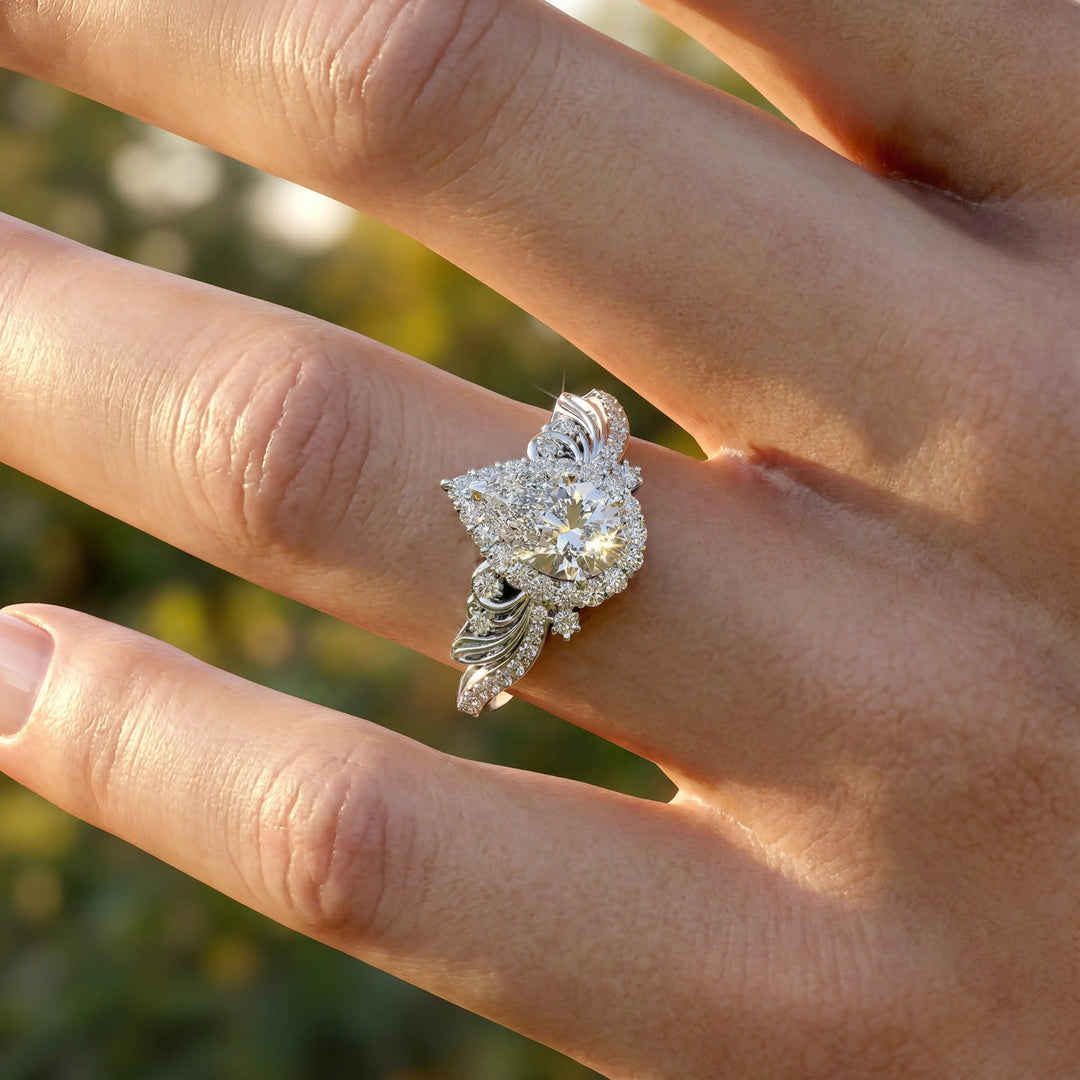 Vintage pear-shaped diamond engagement ring with ornate halo and sculpted detailing.
