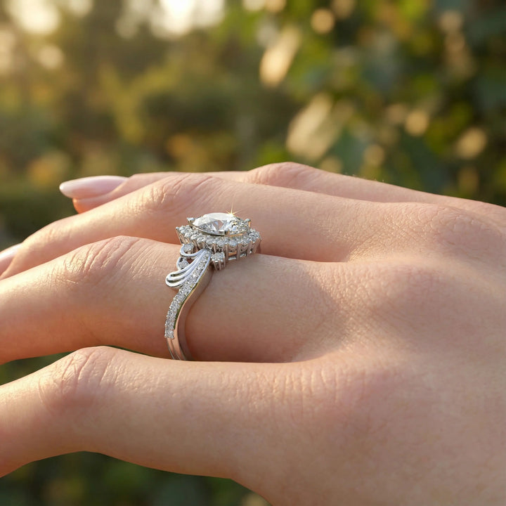 Vintage pear-shaped diamond engagement ring with ornate halo and sculpted detailing.