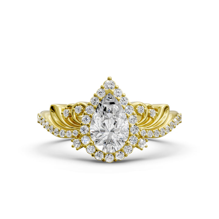 Vintage pear-shaped diamond engagement ring with ornate halo and sculpted detailing.