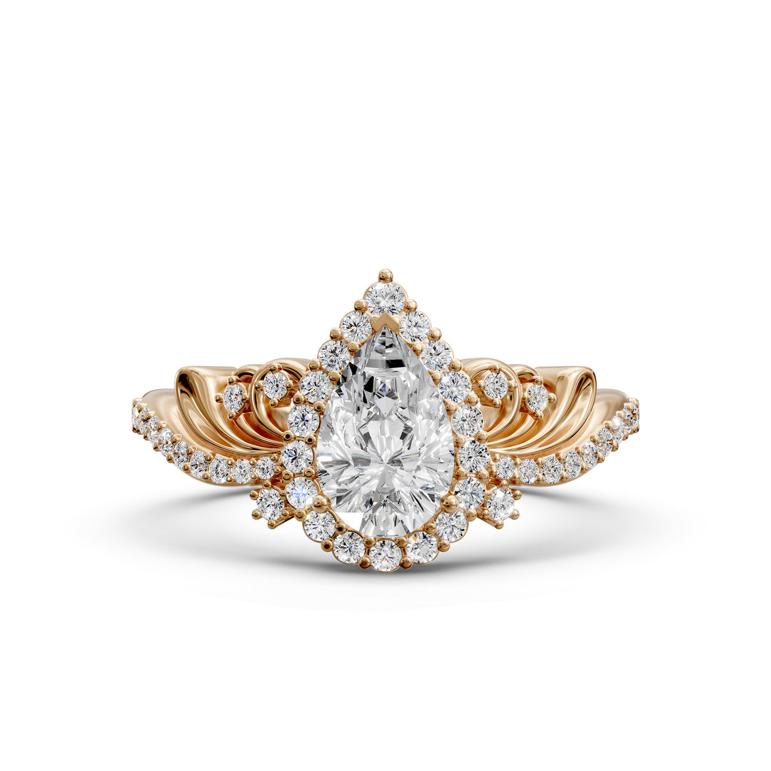Vintage pear-shaped diamond engagement ring with ornate halo and sculpted detailing.