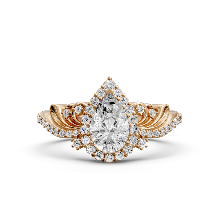 Vintage pear-shaped diamond engagement ring with ornate halo and sculpted detailing.