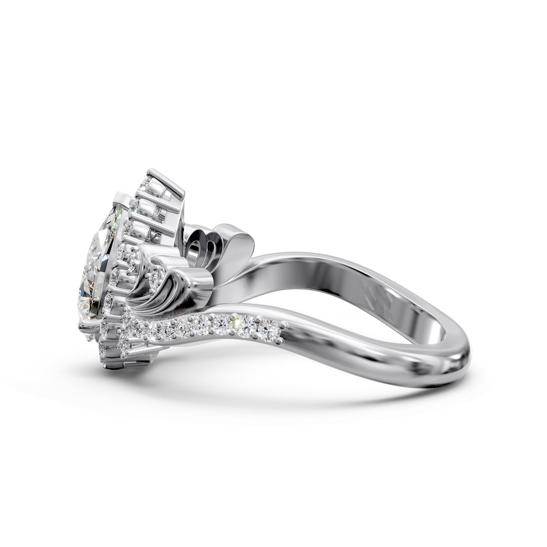 Vintage pear-shaped diamond engagement ring with ornate halo and sculpted detailing.