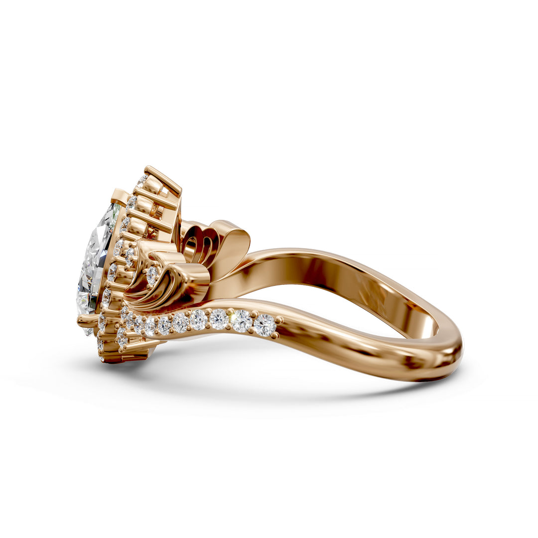 Vintage pear-shaped diamond engagement ring with ornate halo and sculpted detailing.