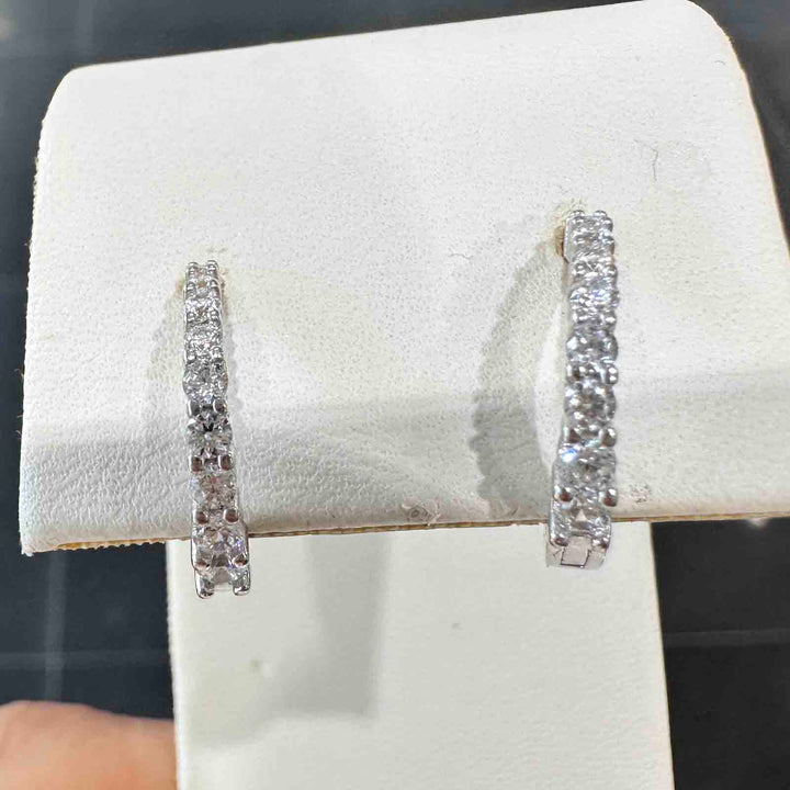 10K white gold hoop earrings with cubic zirconia stones on the front half and a simple back design.