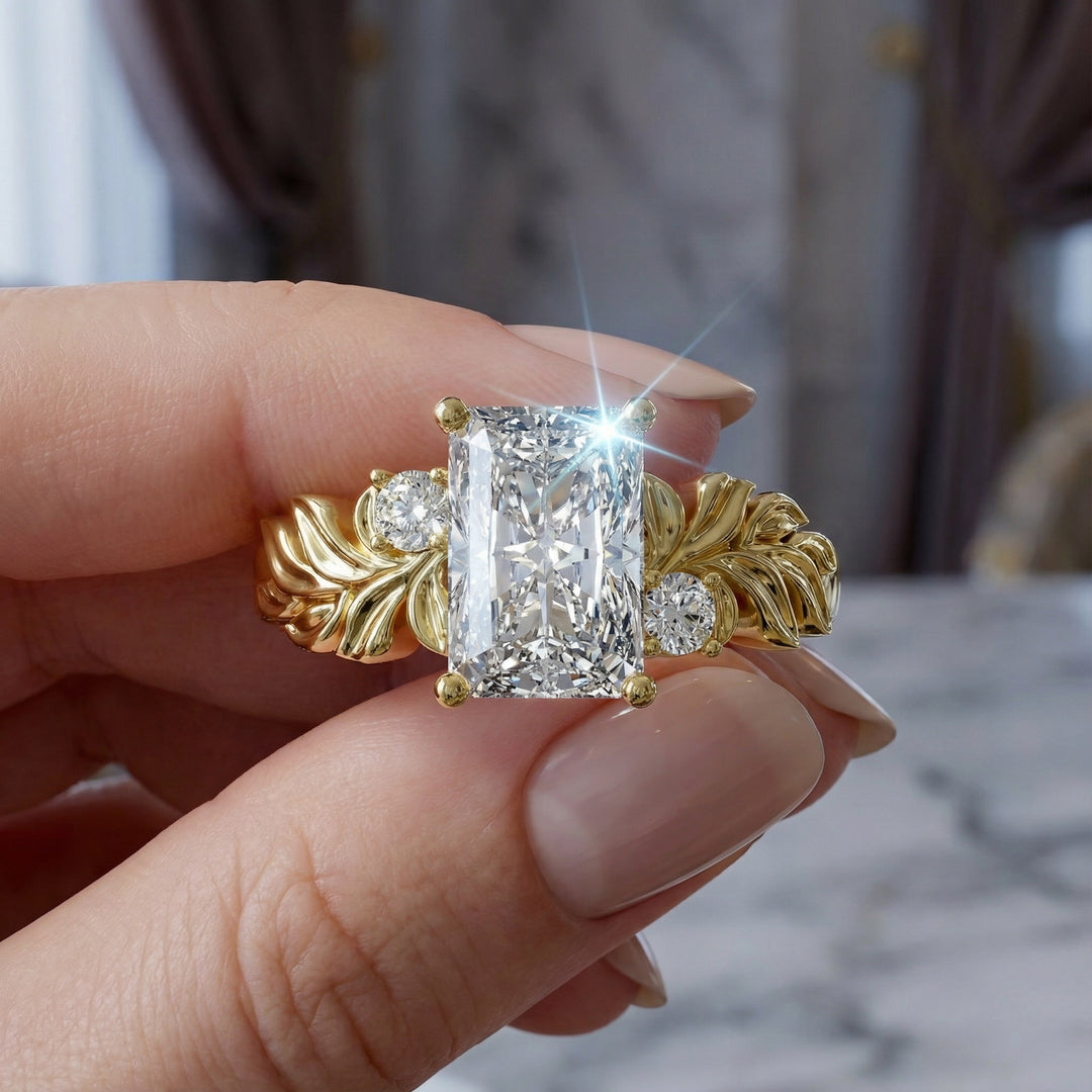 Radiant cut diamond engagement ring with sculpted leaf motif and side stones.