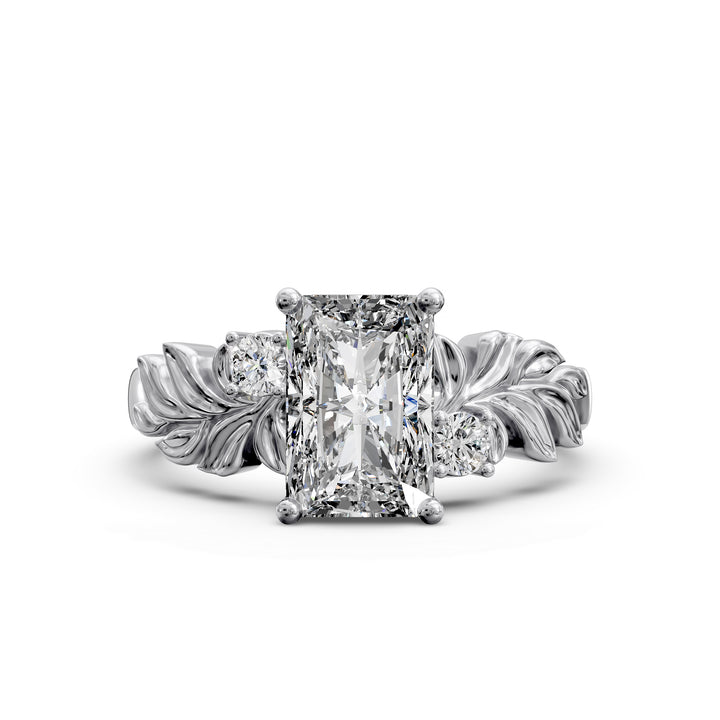 Radiant cut diamond engagement ring with sculpted leaf motif and side stones.