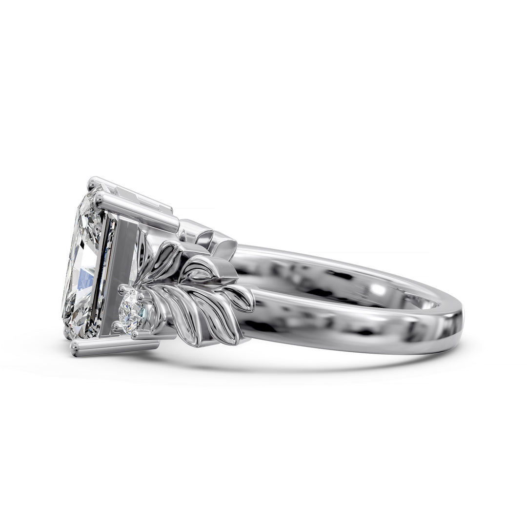 Radiant cut diamond engagement ring with sculpted leaf motif and side stones.