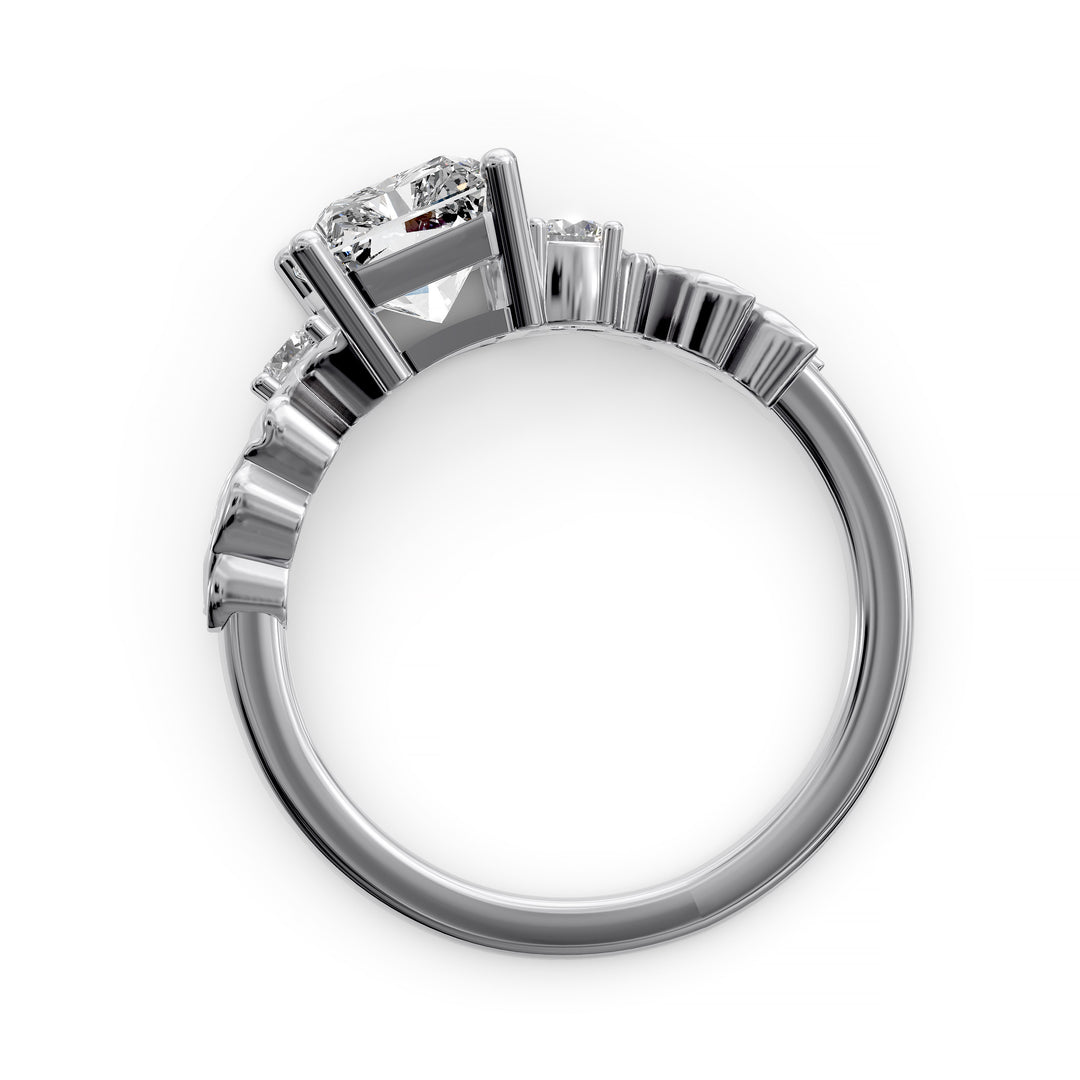 Radiant cut diamond engagement ring with sculpted leaf motif and side stones.