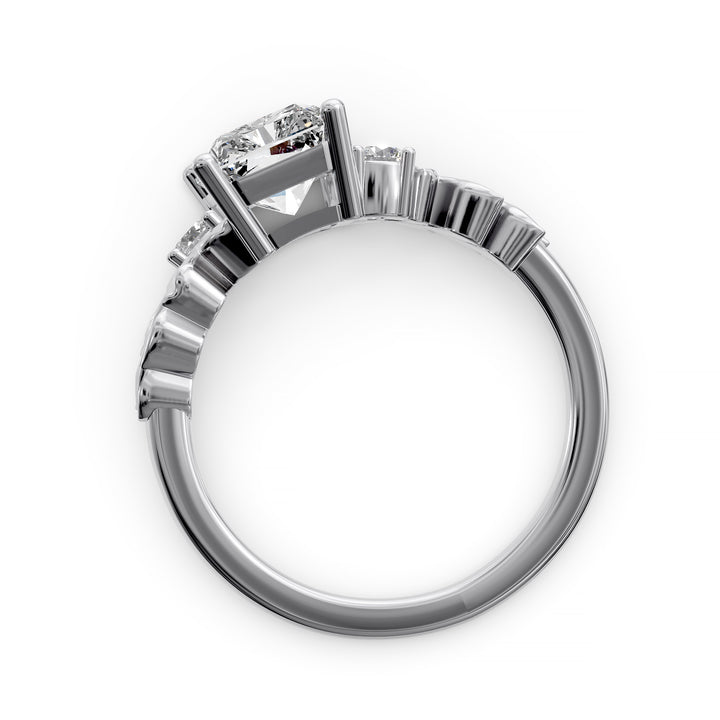 Radiant cut diamond engagement ring with sculpted leaf motif and side stones.