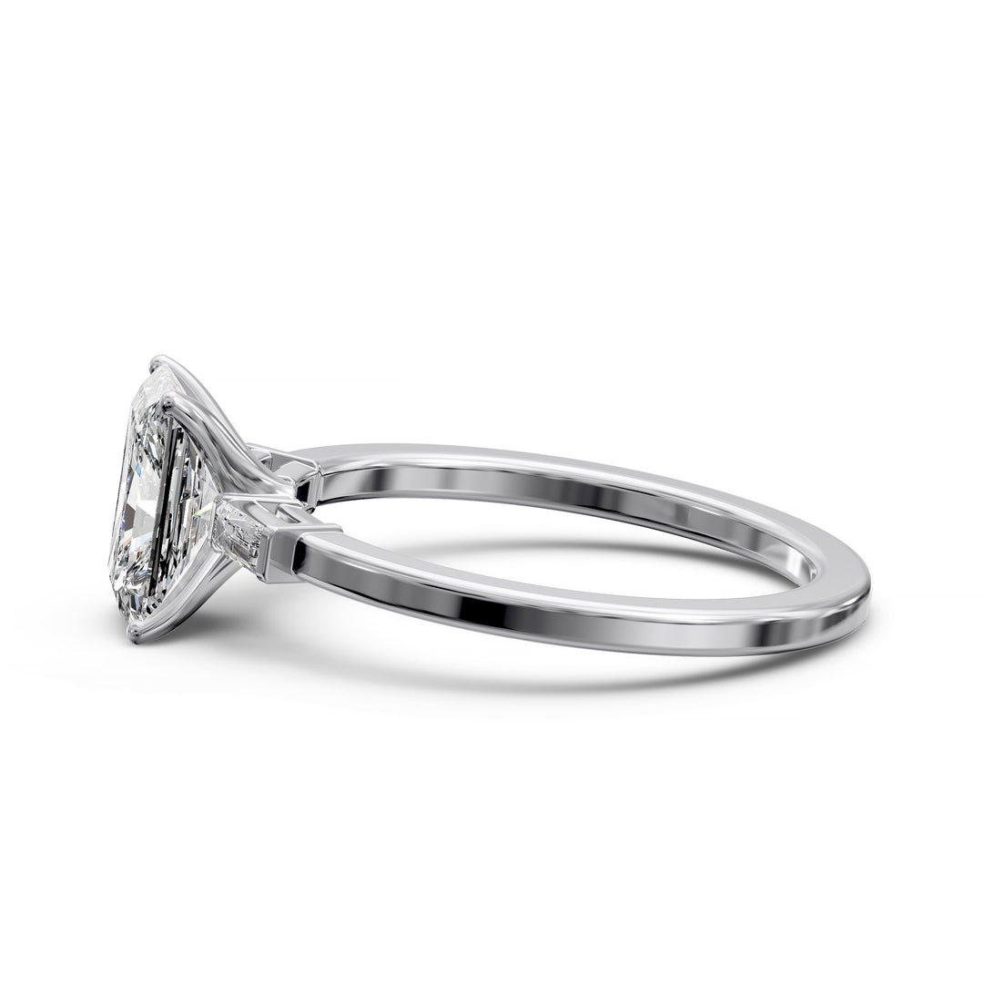 Radiant cut three stone engagement ring with tapered side diamonds.