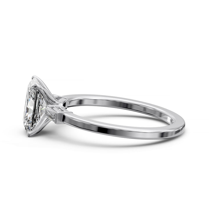 Radiant cut three stone engagement ring with tapered side diamonds.