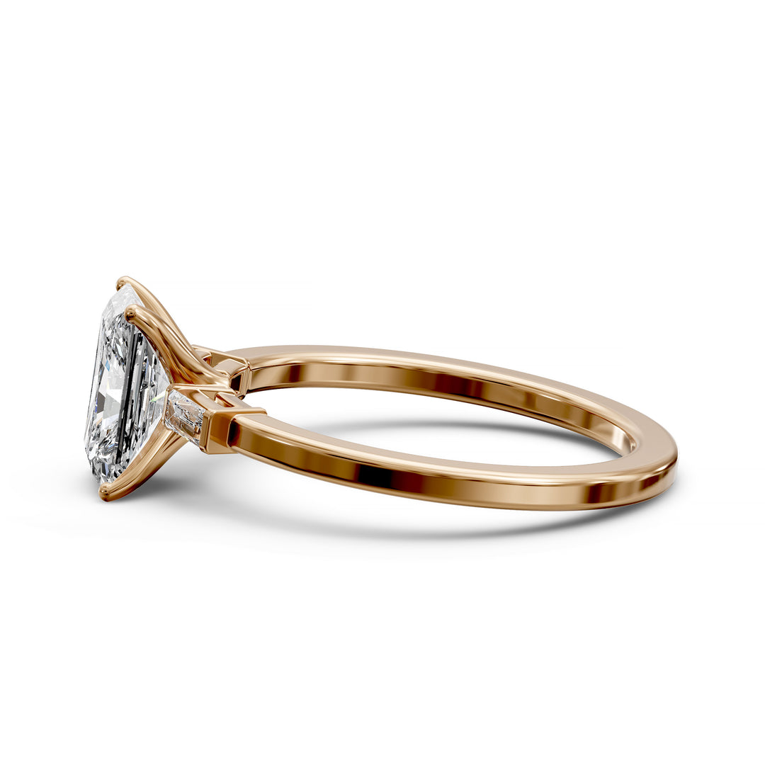 Radiant cut three stone engagement ring with tapered side diamonds.
