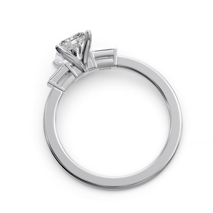 Radiant cut three stone engagement ring with tapered side diamonds.