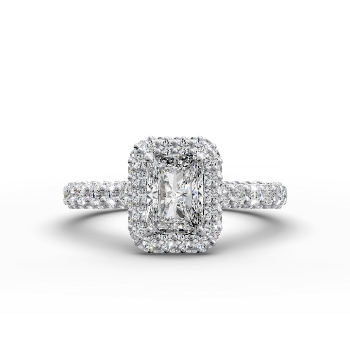 Radiant-cut diamond halo ring with triple prong-set cathedral band shown in front view.