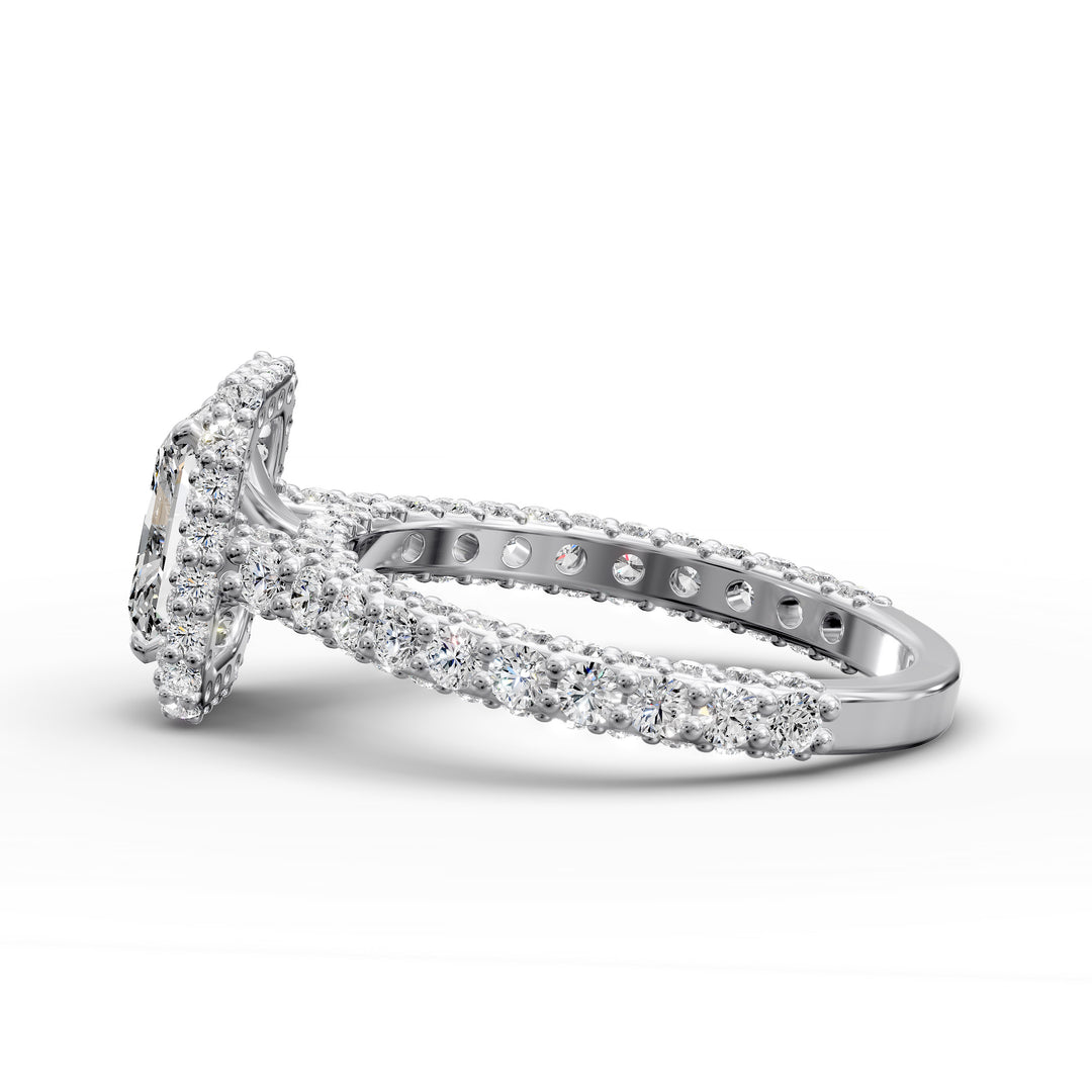 Radiant-cut diamond halo ring with triple prong-set cathedral band shown in front view.