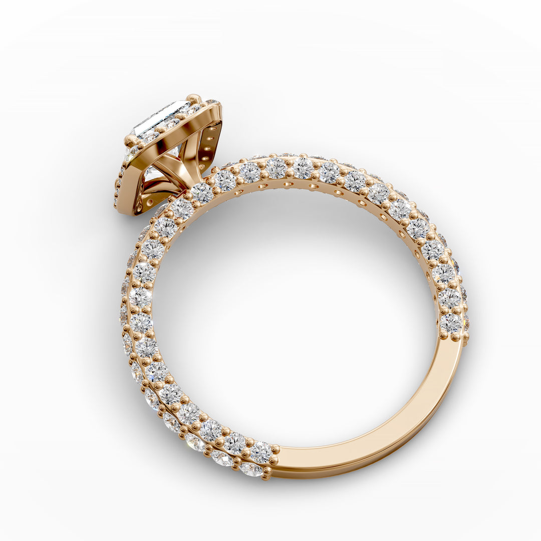 Radiant-cut diamond halo engagement ring with triple prong-set diamond band shown in display view.