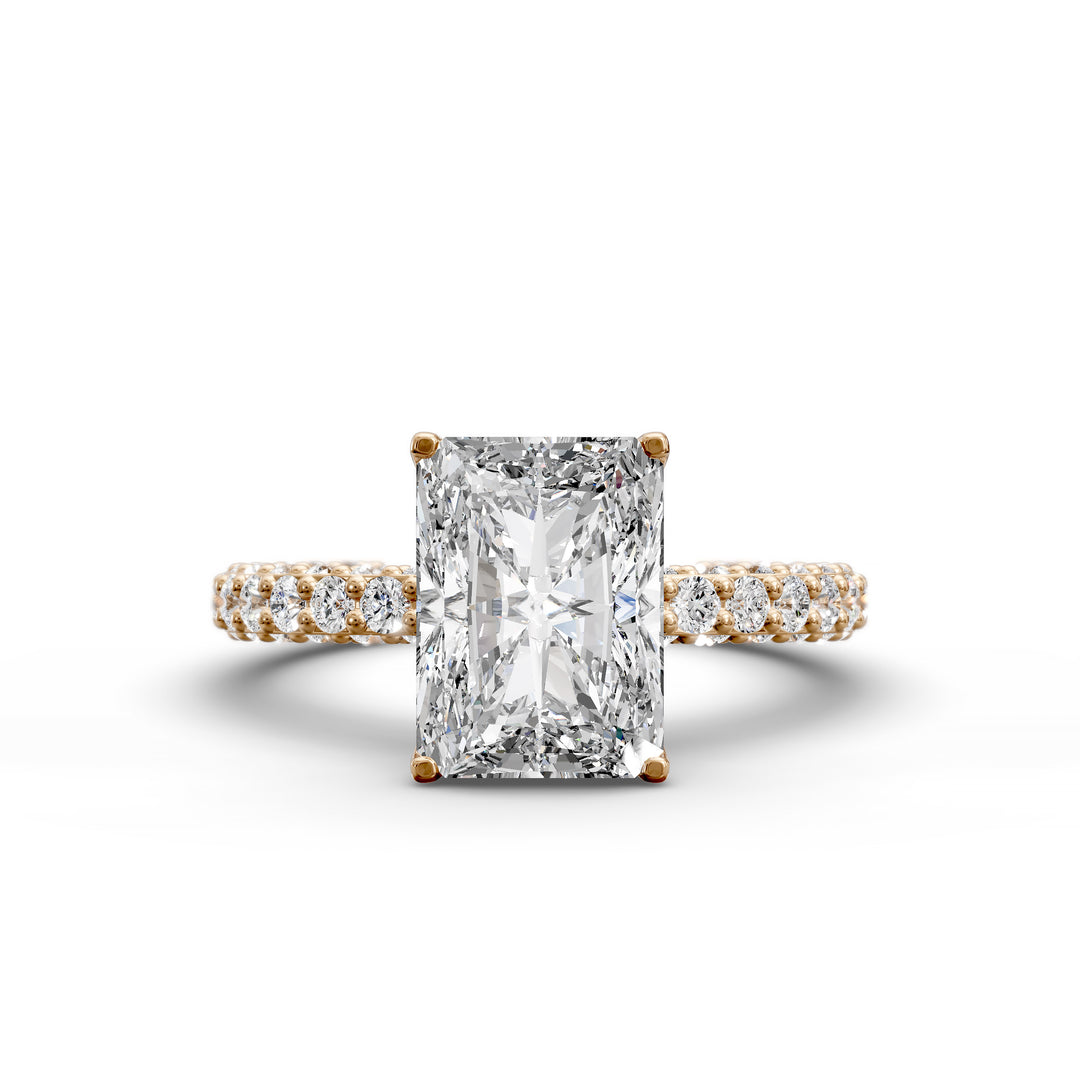 Radiant hidden halo engagement ring with three-row diamond band in studio lighting.