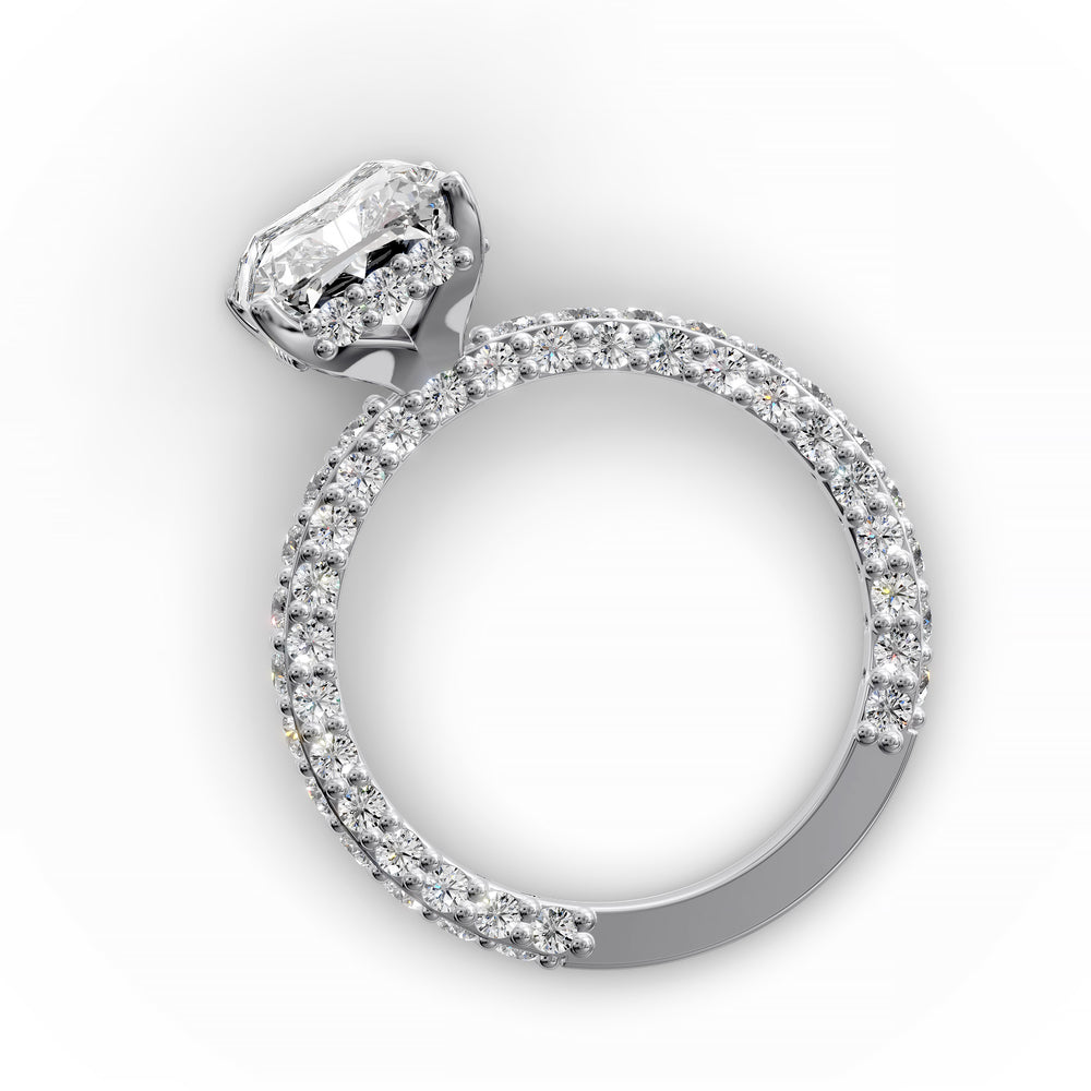 Radiant hidden halo engagement ring with three-row diamond band in studio lighting.