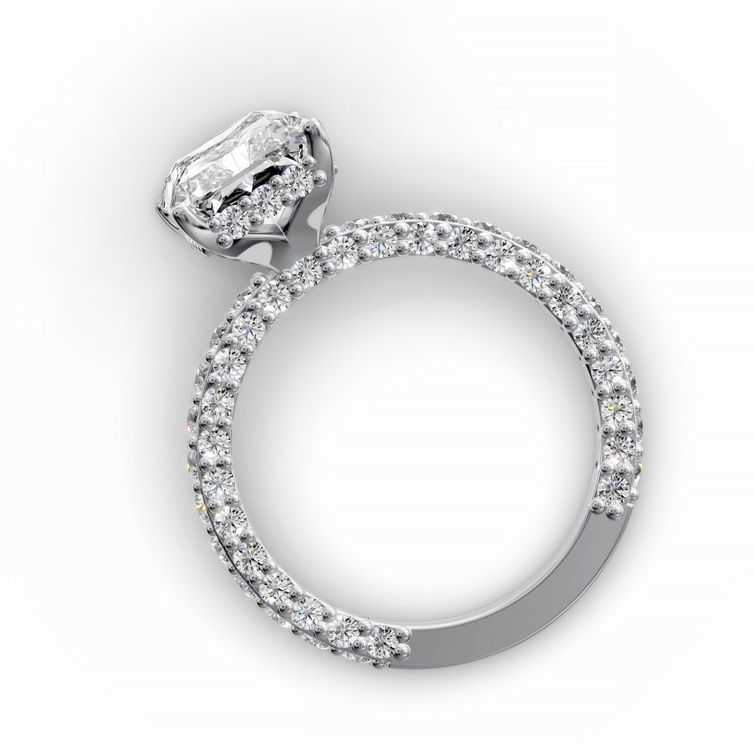 Radiant hidden halo engagement ring with three-row diamond band in studio lighting.